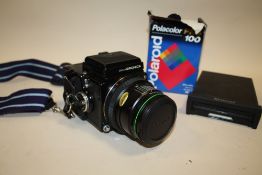 A VINTAGE ZENZA BRONICA CAMERA TOGETHER WITH POLAROID ITEMS