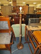 A CIRCA 1930'S OAK BARLEYTWIST TAPERED LAMP STANDARD
