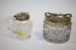 A HALLMARKED SILVER TOPPED CUT GLASS CONDIMENT JAR TOGETHER WITH A SILVER PLATED CUT GLASS SUGAR