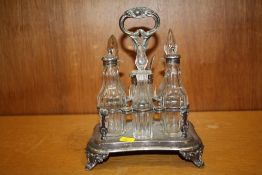 A SILVER PLATED SIX BOTTLE CRUET SET WITH HALLMARKED SILVER TOPPED PEPPERETTES