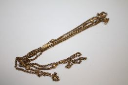 A YELLOW METAL MUFF CHAIN