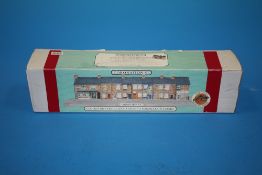 A BOXED COLLECTORS SERIES HAND PAINTED MODEL OF CORONATION STREET