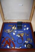 A GLAZED TABLETOP DISPLAY CABINET AND CONTENTS TO INCLUDE A SILVER HANDLED BUTTON HOOK, COSTUME