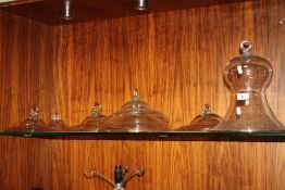 A COLLECTION OF GLASS PLATE COVERS ETC.