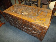 A CARVED EASTERN HARDWOOD COFFER WITH METAL DECORATIVE HINGES H-50 W-95 CM