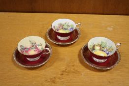 THREE PARAGON CHINA CUPS AND SAUCERS WITH INTERIOR FRUIT PATTERN