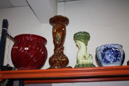 A LARGE RED JARDINAIRE, TOGETHER WITH A SMALLER BLUE AND WHITE EXAMPLE AND TWO JARDINAIRE STANDS