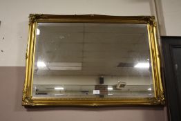 A GILT FRAMED BEVEL EDGED WALL MIRROR