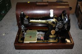 A MAHOGANY CASED VINTAGE SINGER SEWING MACHINE