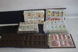 FIVE ALBUMS OF COLLECTORS' CARDS containing complete and incomplete sets by Churchman, Ogdens,