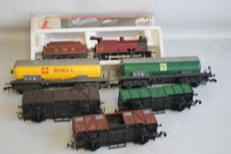 A BOXED O GAUGE LMS STEAM LOCOMOTIVE AND TENDER; together with five unboxed pieces of rolling stock,