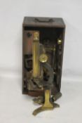A 19TH CENTURY LACQUERED BRASS MONOCULAR MICROSCOPE, in fitted wooden case with a selection of