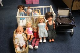 SEVEN LARGE VINTAGE DOLLS PLUS A DOLL IN A MOSES BASKET also including two dolls cots and a blue