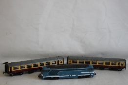 AN UNBOXED O GAUGE LIMA DIESEL LOCOMOTIVE and two unboxed LMS carriages.
