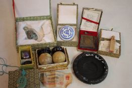 A COLLECTION OF BOXED ORIENTAL OBJECTS, to include a snuff bottle, health balls, a model Si Nan