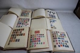 A COLLECTION OF WORLD STAMPS in seven albums.