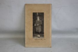 A FULL LENGTH PHOTOGRAPH OF KING EDWARD VII IN A KILT, signed Edward R, 1904, 31 cm x i9 cm