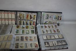 SIX FOLDERS CONTAINING SETS OF COLLECTORS CARDS BY FRYS, EMBASSY, KNOCKOUT, CADET, CASTROL,