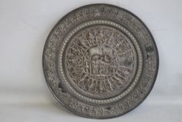 AN ANTIQUE INDIAN COPPER AND WHITE METAL CHARGER, depicting a central Goddess figure surrounded by
