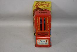 A BOXED 1950S TIN PLATE CHOCOLATE SLOT MACHINE, with original Cadburys bars inside