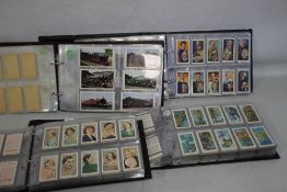 FOUR FOLDERS CONTAINING SETS OF COLLECTORS CARDS BY WD AND HO WILLS, JOHN PLAYER, OGDEN, ABC,