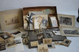 A BOX OF EARLY-MID 20TH CENTURY PHOTOGRAPHS, mainly of people to include an album of postcard types