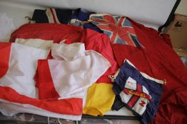 A QUANTITY OF VINTAGE FLAGS, to include three Union Jacks.