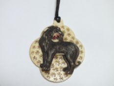 A CARVED AND PIERCED VICTORIAN TYPE IVORY PENDANT DECORATED WITH A LION, H 5.5 cm A/FCondition