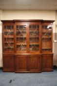 A LARGE MAHOGANY BREAKFRONT LIBRARY BOOKCASE, the upper section with four astragel glazed doors,