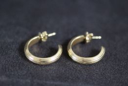 A PAIR OF THEO FENNELL 18 CARAT GOLD HALF HOOP EARRINGS, bearing full hallmarks and named on the