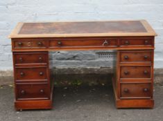 A MID VICTORIAN MAHOGANY TWIN PEDESTAL DESK, having an arrangement of nine drawers with fluted glass