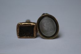 AN ANTIQUE BRASS FOB SET WITH A ROCK CRYSTAL INTAGLIO DEPICTING THE FIGURE EQUITY, 2 x 1.5 cm,