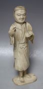 A JAPANESE CARVED IVORY OKIMONO, depicting an artist / scholar, the right hand with a missing