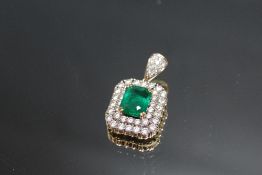 AN EMERALD AND DIAMOND ART DECO PENDANT, set with a central emerald cut emerald of an estimated 3.