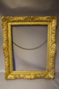A MID 17TH CENTURY LOUIS XIV DECORATIVE GILT PICTURE FRAME, frame W 10 cm, framed rebate 58 x 45 cm