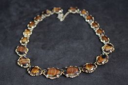 A VINTAGE TIGERS EYE STYLE AGATE NECKLACE, in a gilt mount