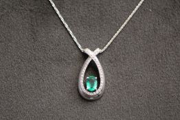 AN EMERALD AND DIAMOND PENDANT ON 14k WHITE GOLD CHAIN, pendant stamped 14k CEI, H 1.25 cm approx
