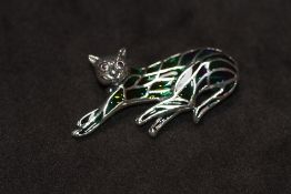 A SILVER PLIQUE A JOUR CAT BROOCH / PENDANT, set with ruby eyes
