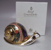 A ROYAL CROWN DERBY LIMITED EDITION 'GARDEN SNAIL' PAPERWEIGHT, number 95 of 4500, gold stopper,