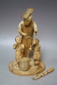 A JAPANESE IVORY OKIMONO, depicting a fisherman with two children with a fishing basket and loose