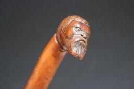 A CARVED WALKING STICK WITH BEARDED MAN HANDLE, L 81 cmCondition Report:some splits to main shaft