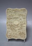 A 19TH CENTURY CARVED ORIENTAL IVORY CARD CASE, one side typically carved with figures and