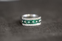 A WHITE GOLD EMERALD AND DIAMOND RING, set with an estimated 1.20 carats of emeralds and twenty