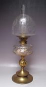 A 19TH CENTURY BRASS AND GLASS OIL LAMP, with circular and bulbous support leading to a cleat