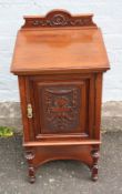 A SMALL EDWARDIAN CARVED MAHOGANY BEDSIDE CUPBOARD, the carved shaped supports united by an under