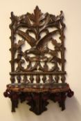 A CARVED OAK BLACK FOREST STYLE FOLDING WALL BRACKET, H 54.5 cm