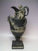 A RESTORED WEDGWOOD BLACK BASALT 'SACRED TO NEPTUNE' WATER EWER, modelled by John Flaxman Sen. (1726
