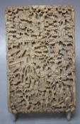 A 19TH CENTURY CARVED CANTON IVORY CARD CASE, typically decorated with figures and pavilions, 11.5