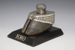 A TAXIDERMY WHITE METAL MOUNTED HOOF, on an ebonised plinth initialled KMO, W 15 cm