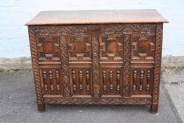 AN ANTIQUE OAK JACOBEAN STYLE DEEP COFFER, the hinged lift-up lid above a carved and moulded